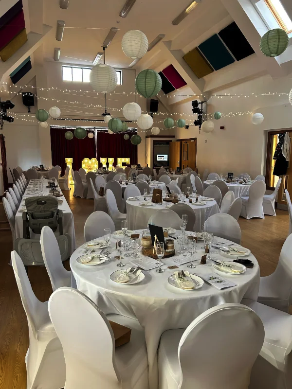 Wedding Table in hall with covered chairs